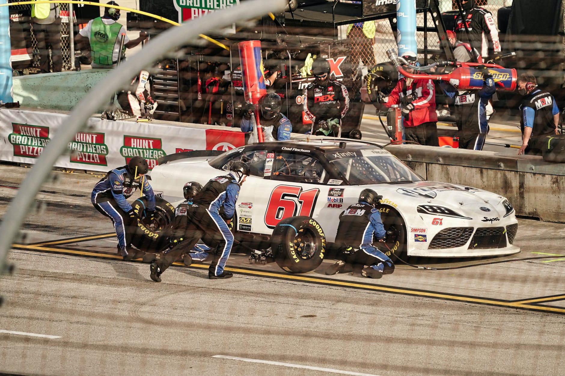 people changing tires in the pit