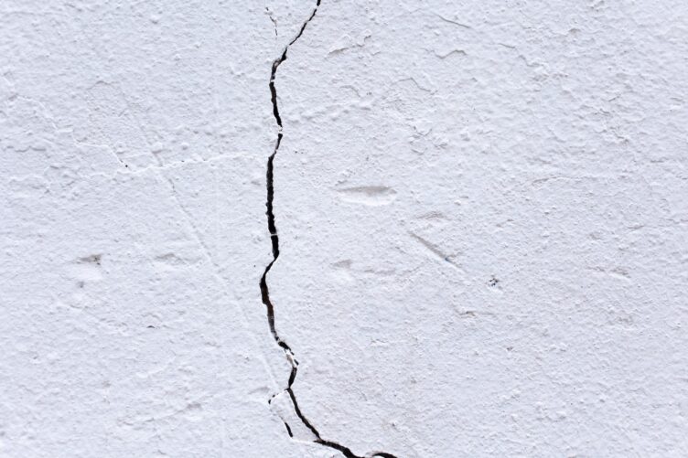 surface of aged white wall with crack